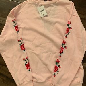 This is a cute pink rose patterned sweatshirt